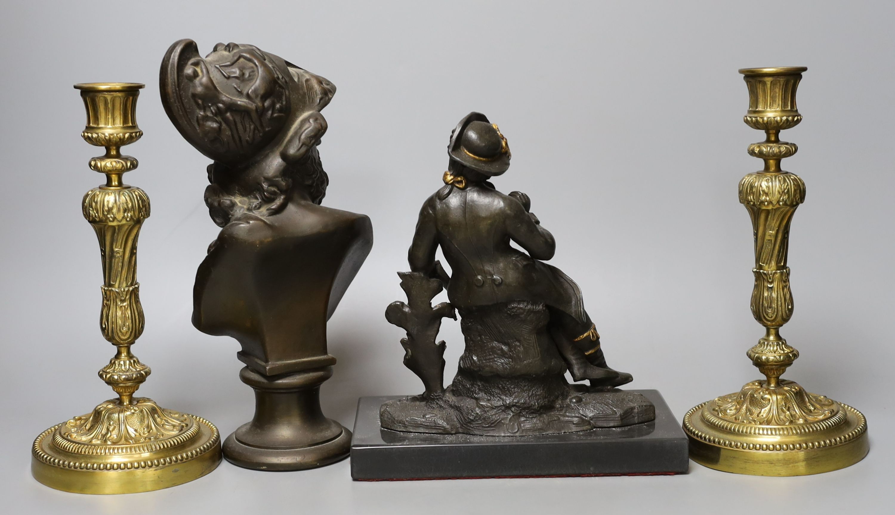 A pair of cast brass candlesticks, 22cm, a bearded portrait bust and a seated figure